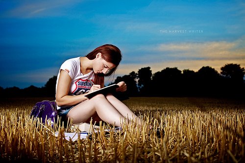 girl writing on a field